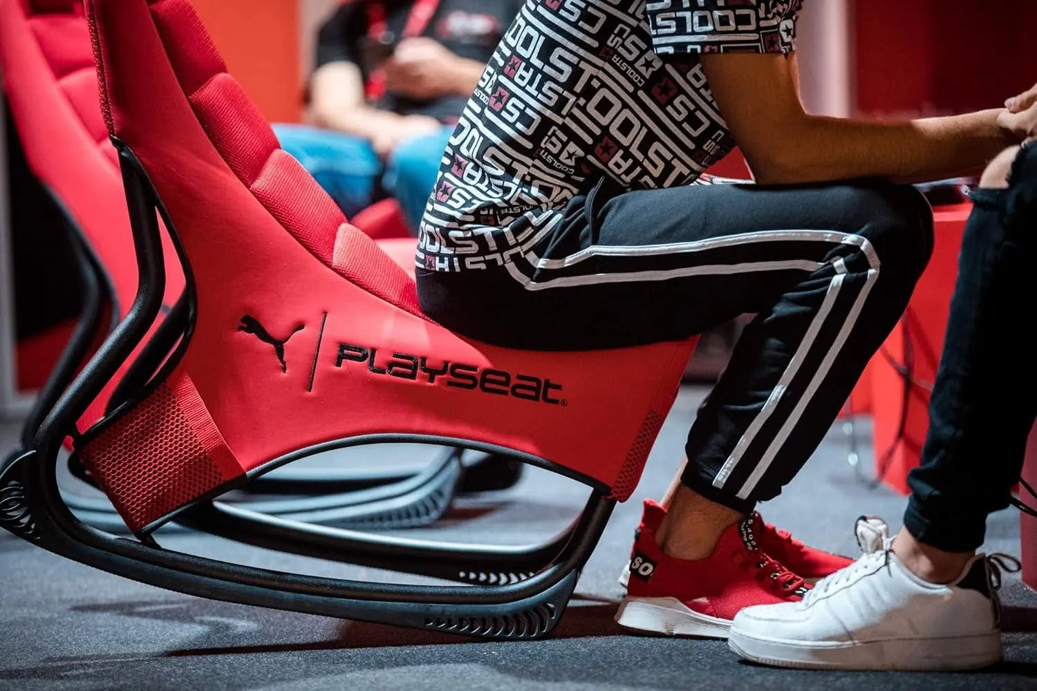 Person seated in the Playseat Active Tilting Gaming Chair Red, logo visible.