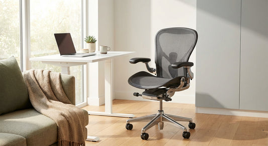 A premium ergonomic mesh office chair positioned in a bright, minimal home office with natural light, a tidy desk, and calming neutral tones.
