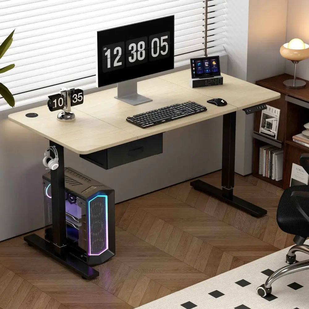 Modern beige height-adjustable desk with black legs and a built-in drawer, featuring an integrated pc tower with glowing rgb lighting.