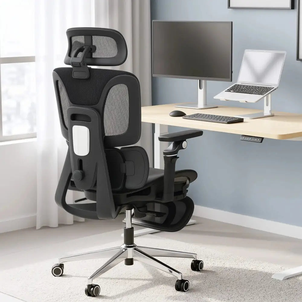 Grey ergonomic high-back mesh office chair with separated backrest and headrest for ergonomic support at a desk.