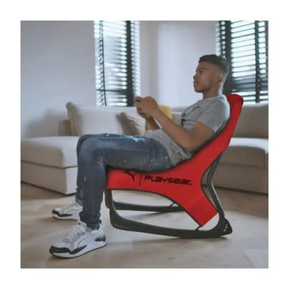 Red and black playseat gaming chair with a sleek, ergonomic design.